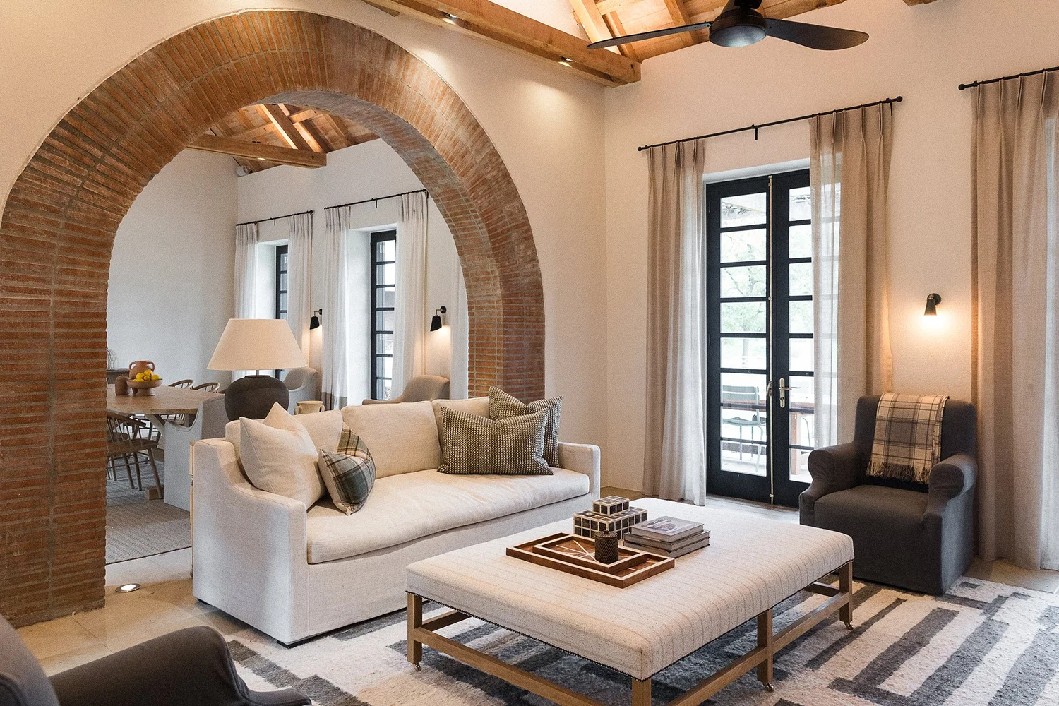 Nieuwe Sion living room with a brick arch and exposed beams